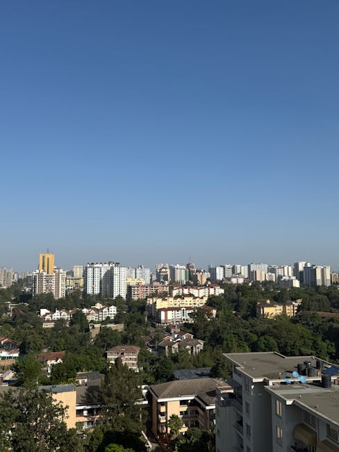 An expansive view of Nairobi's skyline with lush greenery in the foreground.